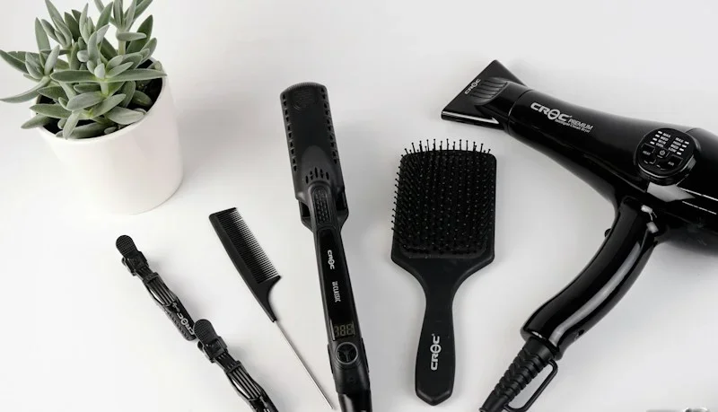 Photorealistic concept display of hair styling brush and hair care accessories
